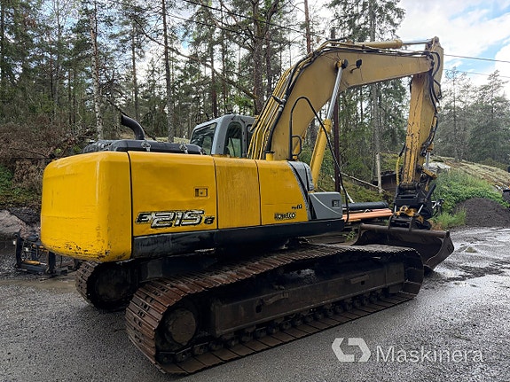 Grävmaskin New Holland E 215B med tillbehör 4 of 27